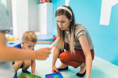 Caucasian teacher making activities with her kids in the kindergarten, preschoolers concept. High quality illustration
