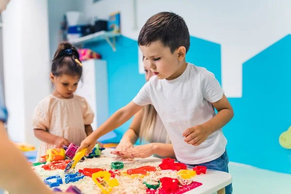 kinetic sand games for childrens development at the nursery. sand therapy. High quality photo