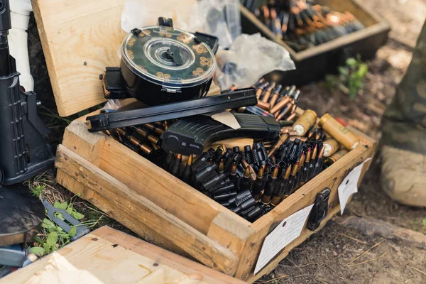 Military equipment bullets ammunition clips stored in wooden boxes. Weaponry. Training ground. Horizontal shot. High quality photo
