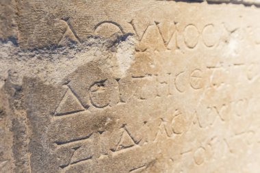 Old Ancient Greek alphabet sentence on a stone wall. Closeup shot. Travel ideas. . High quality photo