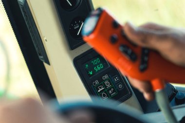 closeup view of farmers hands and tractor controlling machinery. High quality photo