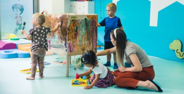 preschoolers painting at nursery, creative art techniques. High quality photo