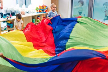 children having lots of fun in the playroom in the kindergarten. High quality photo