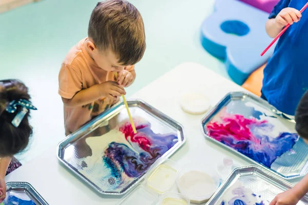 kids making creative paintings with water and paints. High quality photo