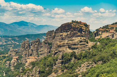 Stunning and breathtaking monasteries of Meteora, Greece built on high rocky formations. Natural view. Drone shot. Blue sky with fluffy clouds. High quality photo