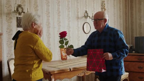 Loving Caucasian Elderly Husband Surprising His Wife Red Rose Gift — Stockvideo