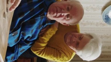 Sad, lost and worried caucasian senior couple counting their last coins while sitting at the table. Financial Crisis. Low pension.. Vertical. High quality 4k footage