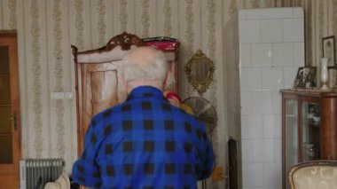 Happy womens day. Caring and loving caucasian elderly husband surprising his wife with a red rose and a gift bag. Happy and thankful woman hugging her husband. High quality 4k footage