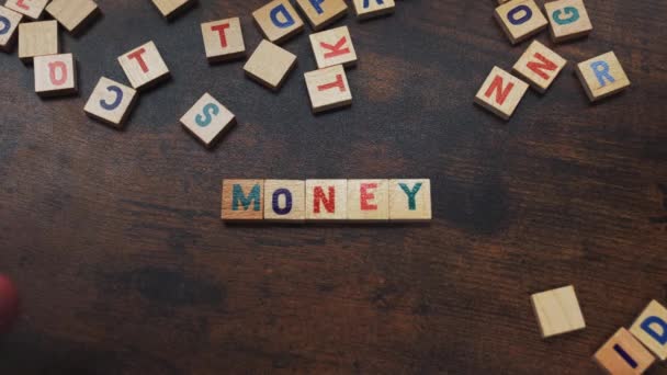 Money Savings Concept Represented Little Wooden Wordplay Letters Arranged Dark — Stockvideo