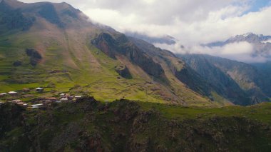 scenic drone shot of the small settlement in the Caucasus mountains, Kazbegi, Georgia. High quality photo