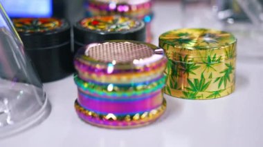 05.28.2022 Warsaw, Poland. Closeup shot of colourful metallic weed crashers. Alternative medicine in CBD CBG cannabis. . High quality 4k footage