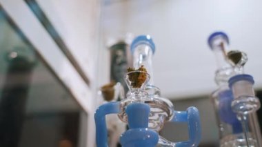 Closeup shot of three different in size and color bongs for smoking medical marijuana. Cannabis CBG CBD placed in each of them. Alternative medicine. High quality 4k footage