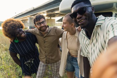 multiethnic group of friends taking a selfie and smiling to the camera. High quality photo