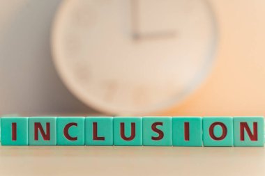 The word INCLUSION made of colorful scrabble tiles. Every young person, regardless of their sexual orientation or gender identity, deserves equal access to opportunities and services and their safety