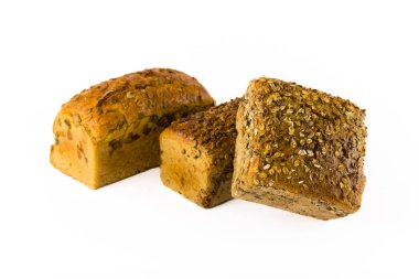 Three whole wheat loaves of bread with different toppings - pumpkin seeds, sunflower seeds, and mixed oats and sunflower seeds. Isolated on white background. Baking advertisement concept. High quality