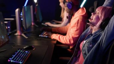 team of professional eSport gamers playing in competitive video games on a cyber games tournament, medium shot. High quality 4k footage