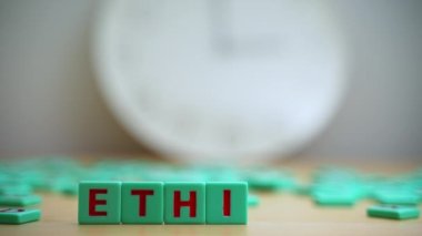 The word ETHICS made of small colorful cubes and many scrambled letters laying around on the table. Core Values. Integrity Ethics Principals And Accountability. High quality 4k footage