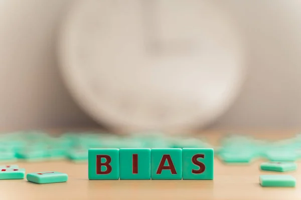 The word BIAS made of small colorful game board pieces with letters imprinted on them. Break the bias movement support. High quality photo