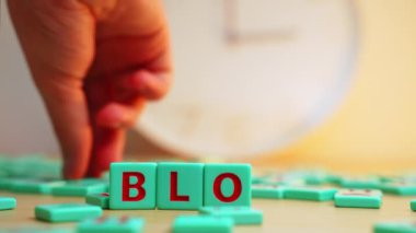 Online marketing, content creation, sharing your life on social media. The word BLOG made of colorful scrabble tiles. High quality 4k footage