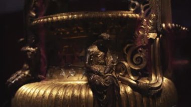 07.13.2022 Thessaloniki, Greece. Beautiful golden jug or pitcher with rich ornaments. Dark light surrounding the object. Archaeological Museum of Thessaloniki. High quality 4k footage