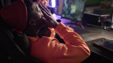young Afro-American man participating in cyber sport tournament, mediu closeup online games concept. High quality 4k footage