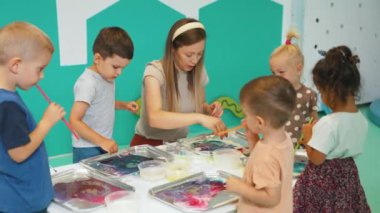 preschoolers having fun and painting in the kindergarten, creative activities for kids. High quality 4k footage