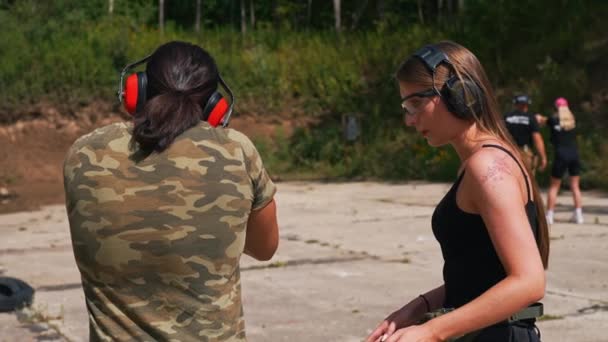 Caucasian Man Woman Wearing Safety Headphones Training Submachine Gun Firing — Stok Video