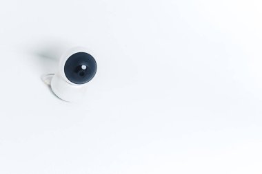 Isolated modern surveillance IP camera on a white wall. High quality photo