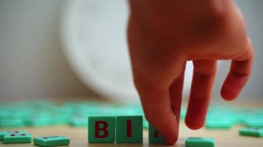 The word BIAS made of small colorful game board pieces with letters imprinted on them. Break the bias movement support. High quality 4k footage