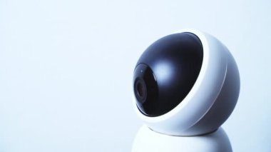 Close up modern surveillance IP camera on a white wall. Security system. High quality 4k footage