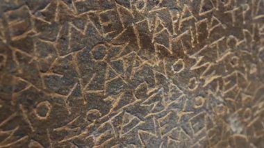 Old Ancient Greek alphabet sentence on a stone wall. Closeup shot. Travel ideas. . High quality 4k footage