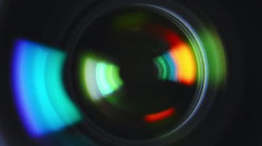 Close-up aperture blades inside of professional camera lens with green color reflections. High quality 4k footage