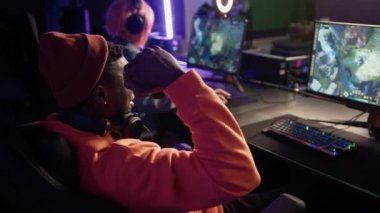 young Afro-American man participating in cyber sport tournament, mediu closeup online games concept. High quality 4k footage