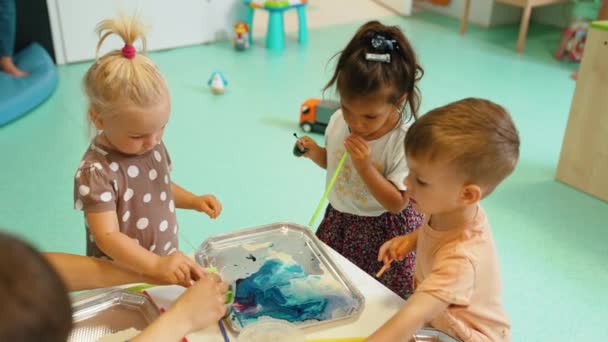 Multi Cultural Nursery School Toddlers Playing Striped Straws Milk Painting — Vídeos de Stock