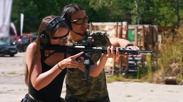 Man Woman Wearing Safety Headphones Goggles Practicing Using Submachine Gun — Stock video