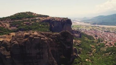 Wide panoramic drone view of one of many Meteora Monasteries placed on the top of rock formations. Summer holidays in Greece. Stunning architecture. High quality 4k footage