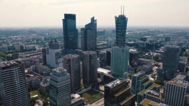 Drone view of skyscrapers over apartment buildings in the center of Warsaw Poland. Blurred horizon cityscape. Horizontal. High quality 4k footage