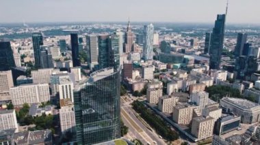 Drone view of Warsaw Poland cityscape with apartment buildings glass skyscrapers and Palace of Culture and Science in the background. Horizontal. High quality 4k footage
