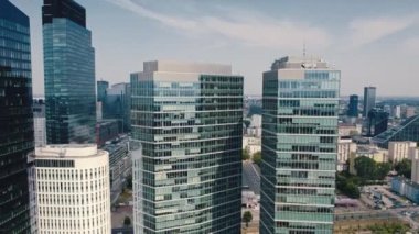 Drone shot of modern glass-covered skyscrapers and apartment buildings in the centre of Warsaw Poland. Horizontal. High quality 4k footage