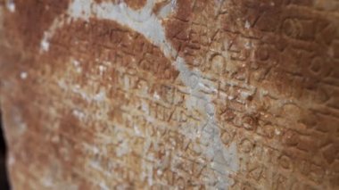 Old Ancient Greek alphabet sentence on a stone wall. Closeup shot. Travel ideas. . High quality 4k footage