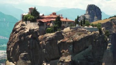 One of the most famous Greek places for tourists interested in religion, architecture, and nature. Stunning building complex of Meteora monastery placed on rock formation. High quality 4k footage