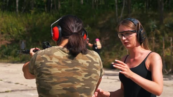 White Woman Man Wearing Safety Gear Outdoor Shooting Range Practicing — Stockvideo