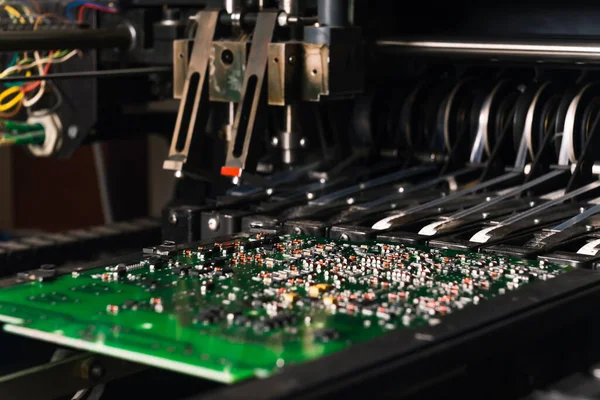 Various production processes of SMD montage. Closeup shot of SMD montage machine placing components directly onto the surface of the PCB. High quality photo