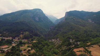 Olimpos Dağı ve onun bitki örtüsü olağandışı insansız hava aracı perspektifinden görülüyor. Tepelere yakın bulutlar. Yunan yaz tatili. Yüksek kalite 4k görüntü