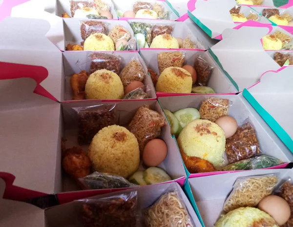 many different cakes in a box in the market