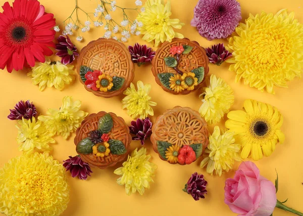 Colorful flower decorated moon cake Chinese mid autumn festival daisy chrysanthemum mum rose baby breath flower red yellow pink purple violet on yellow background