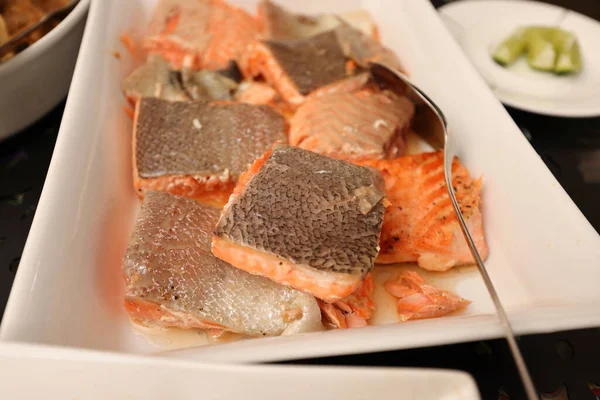 Pink salmon fish fillet pan fried steamed on white ceramic dish — ストック写真