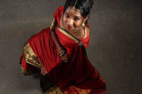 赤オレンジを身に着けているインドの女性参照してくださいジュエリーチョーカーセットネックレスJhumkaイヤリングMaang Tikka腰チェーンスタンドポーズ見て笑顔ムード式頭カバーヒジャーブ — ストック写真