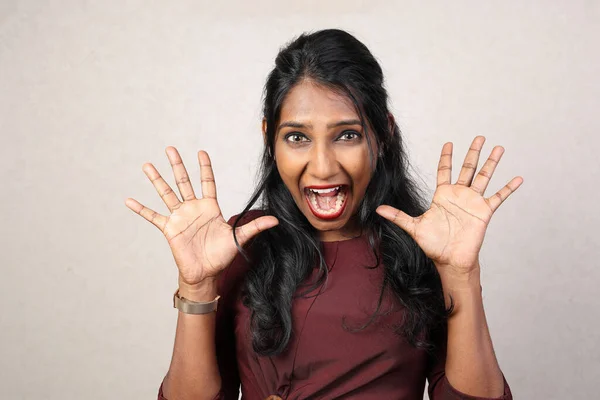 Asian Indian origin dark skin tone beautiful woman facial hand expression surprised shocked hand in air