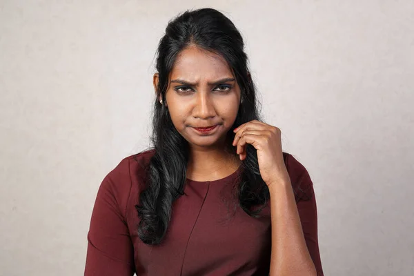 Asian Indian origin dark skin tone beautiful woman facial hand expression looking annoyed grumpy
